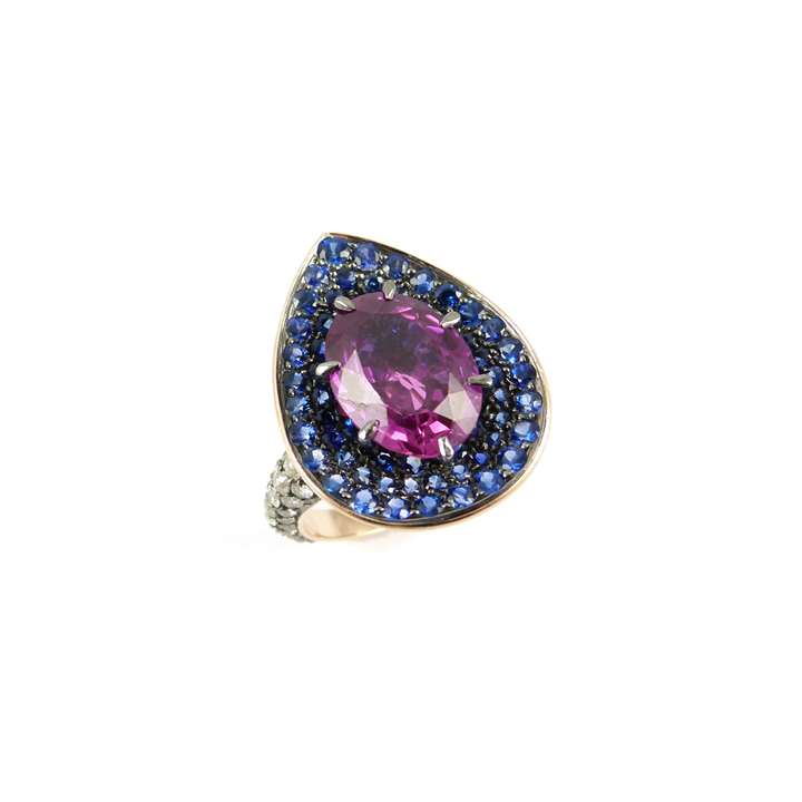 Single stone oval cut pink sapphire, sapphire and diamond cluster ring, centred by a 5.58ct purplish-pink Ceylon sapphire